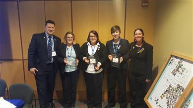 four BPA students and advisor holding awards