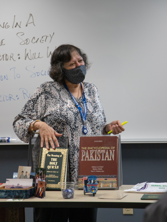 Rubina is discussing a variety Pakistani items in front of class