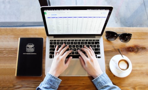 Hands on a laptop keyboard