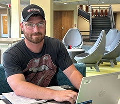 Student on laptop in commons