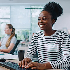 Person sitting at a computer smiling