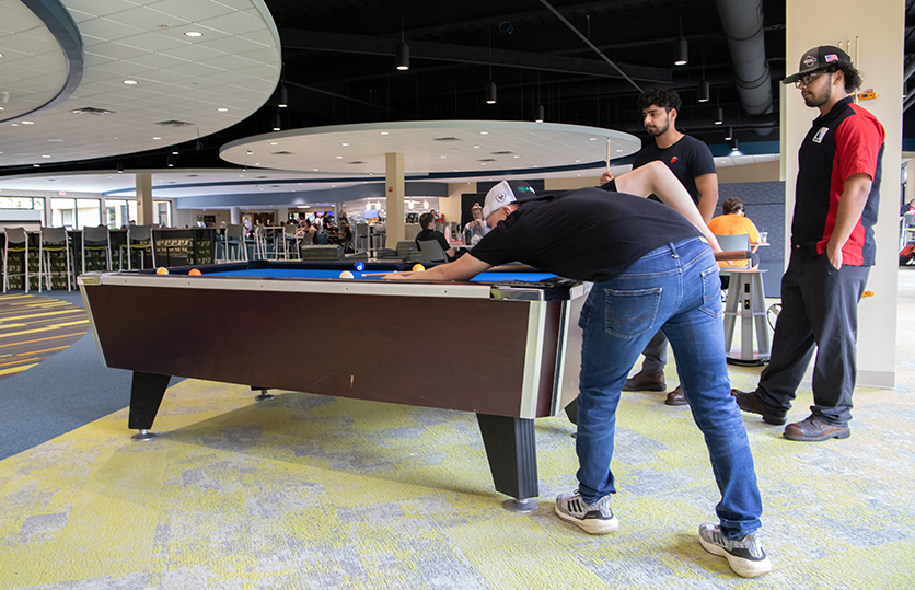 students playing pool in the Student Commons
