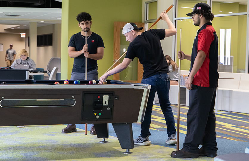 students playing billiards in the commons