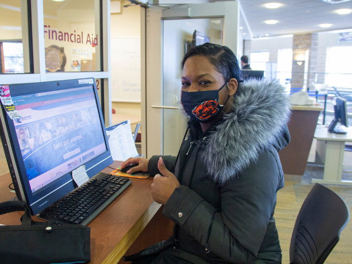 masked female student at computer