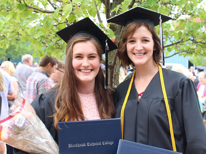 two female graduates standing outside after commencement
